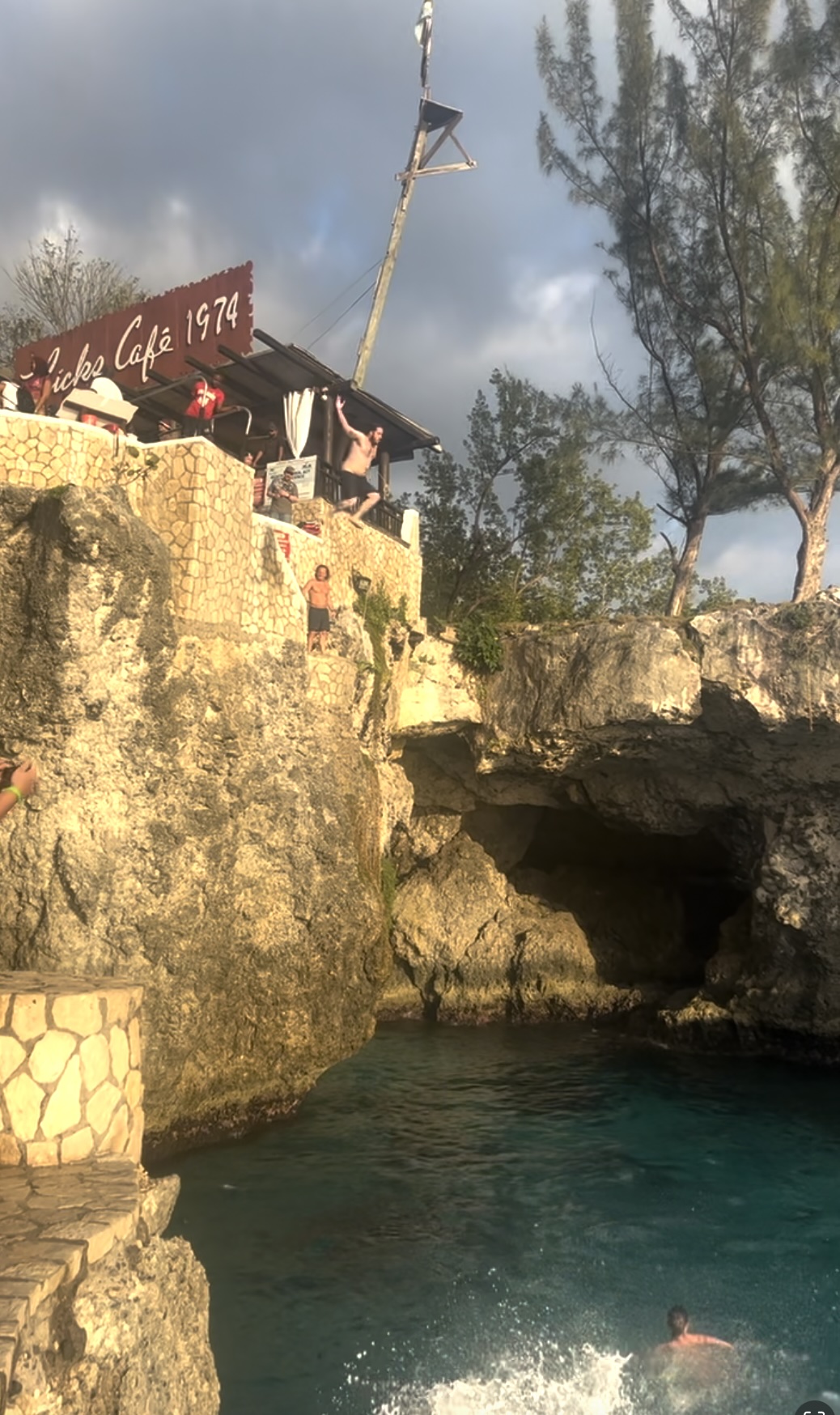 A man jumping off a 35-foot cliff at Ricks Cafe in Negril, Jamaica